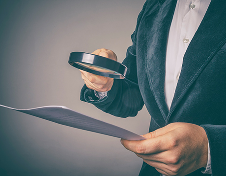 man inspecting a balance sheet